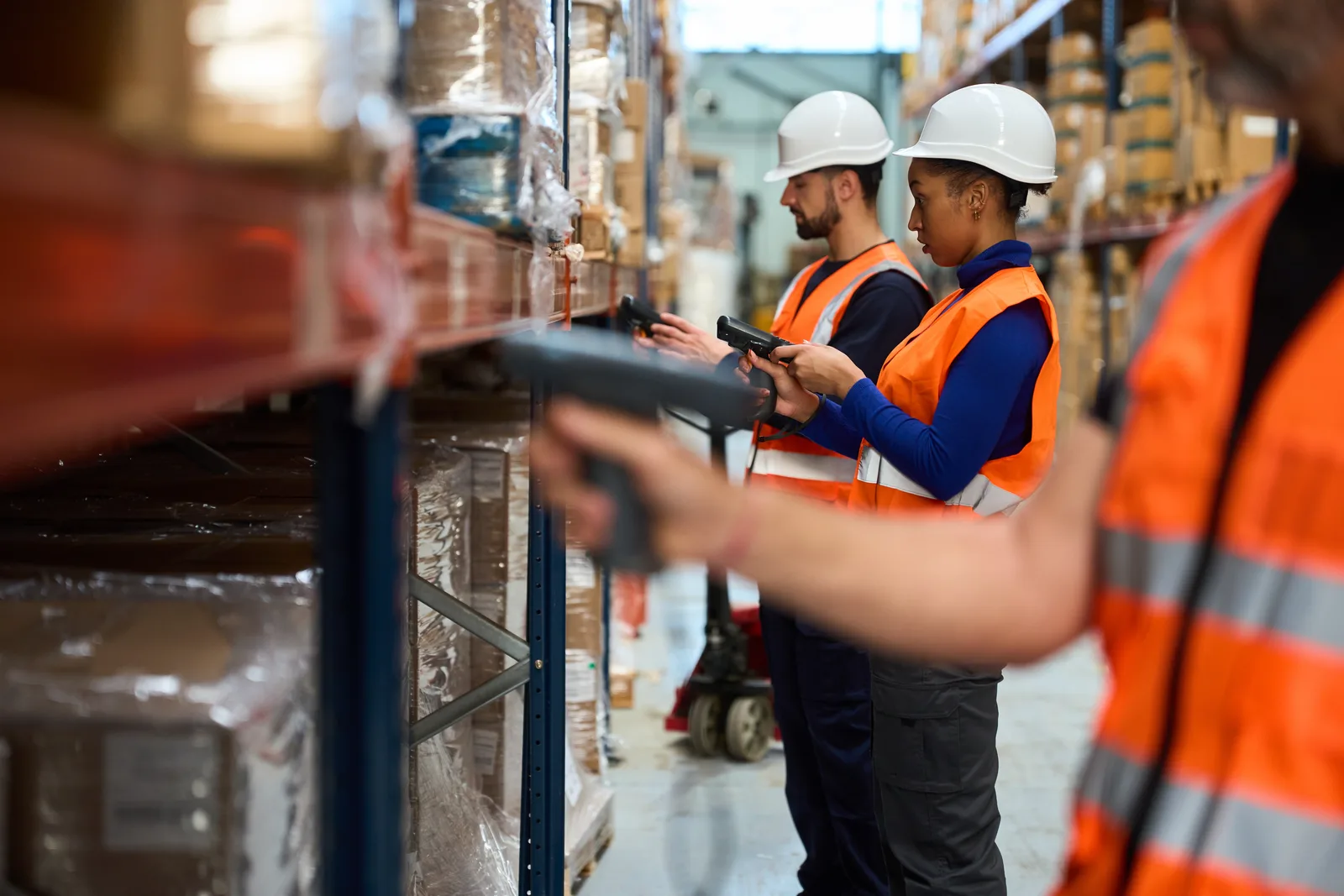 Warehouse team walking through a pallet aisle