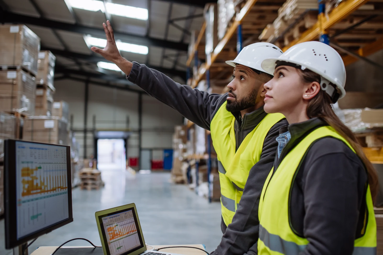 Warehouse leaders comparing capacity information on the floor