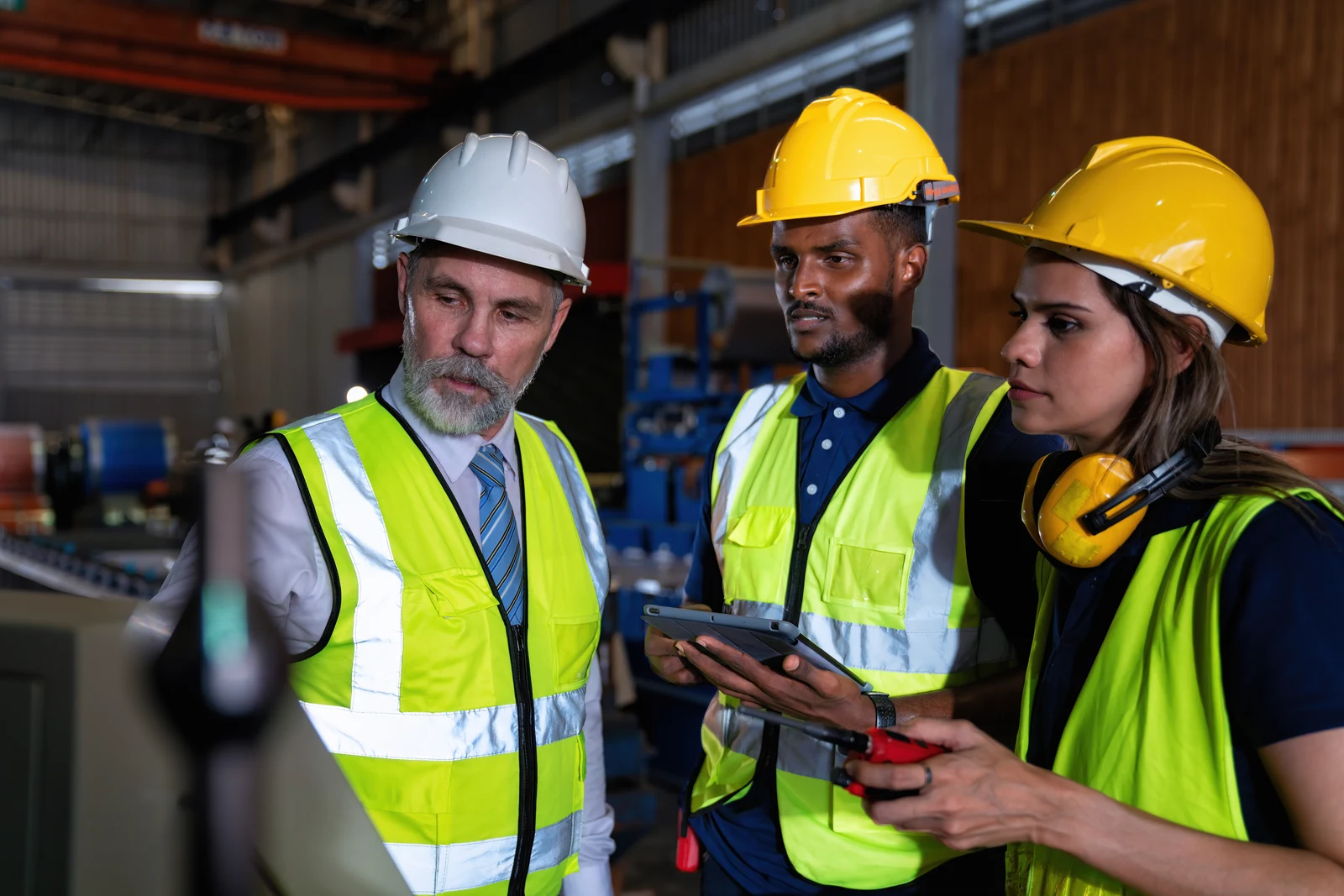 Manufacturing leaders reviewing a capacity plan on a tablet