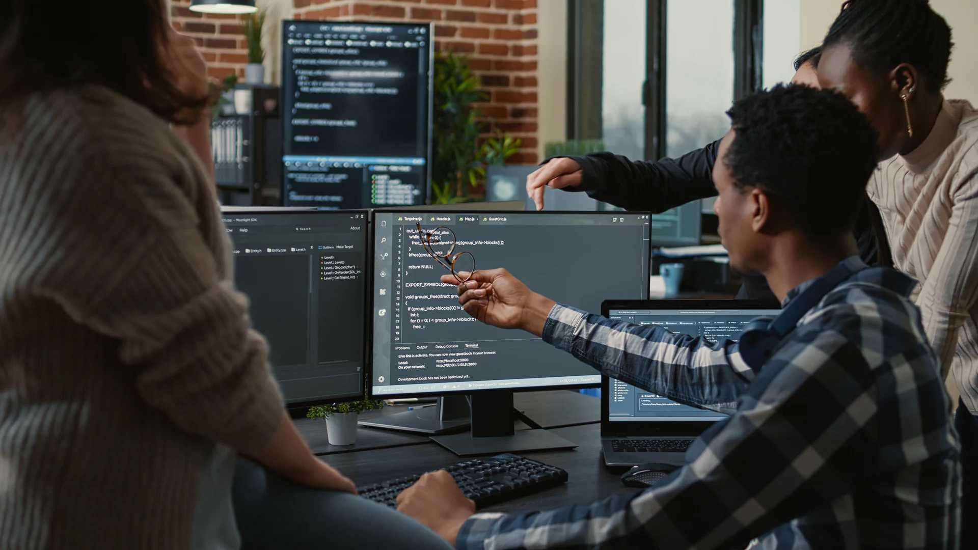 Team reviewing capacity information across several computer screens