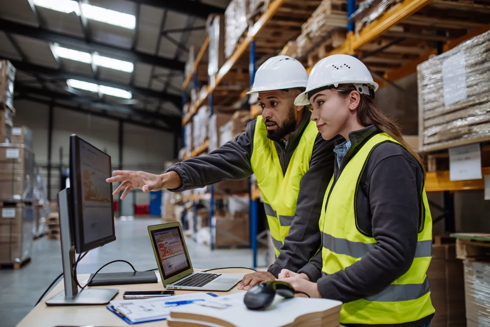 Warehouse team member reviewing operations