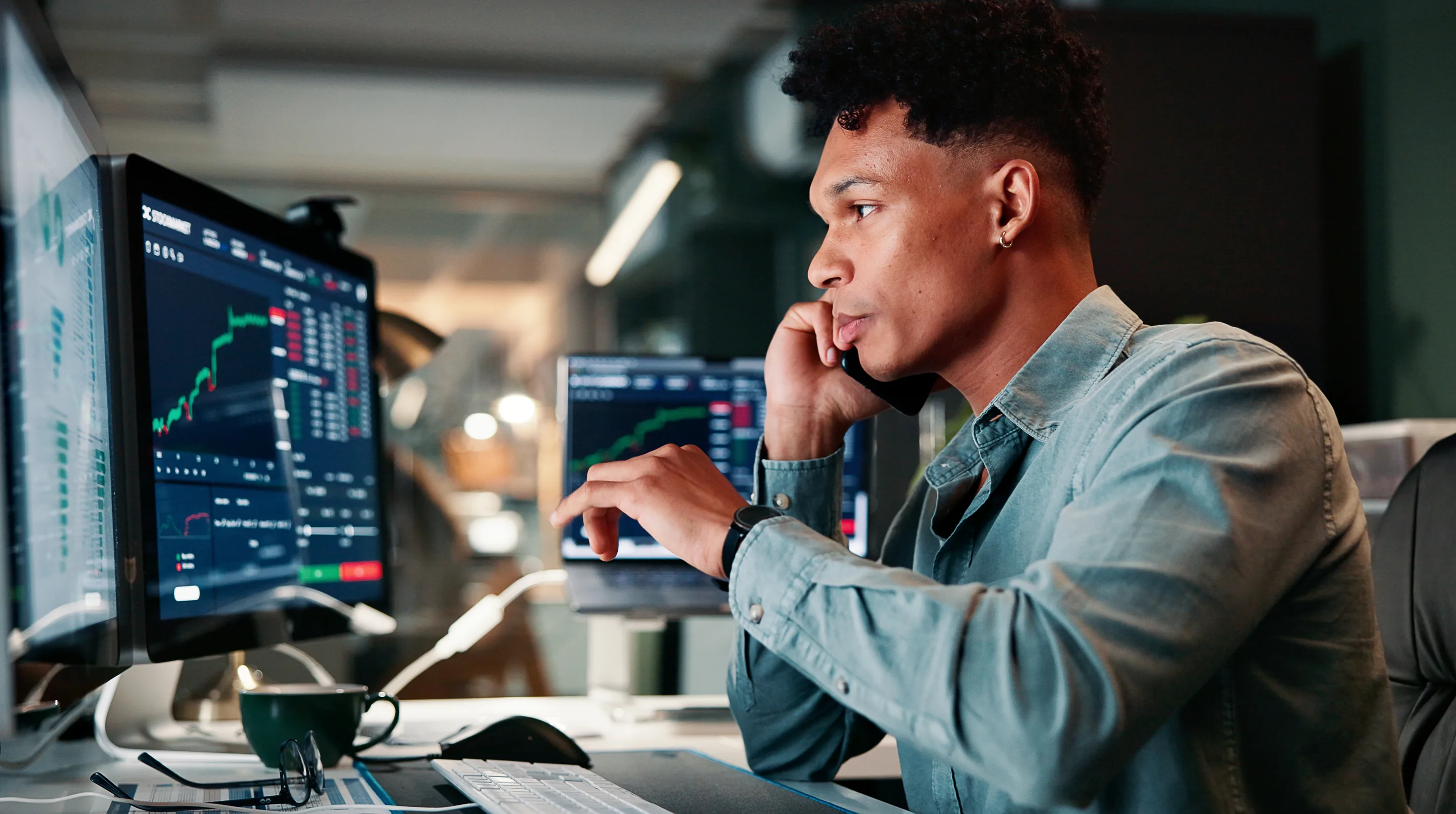 Analyst working with operational data on multiple monitors