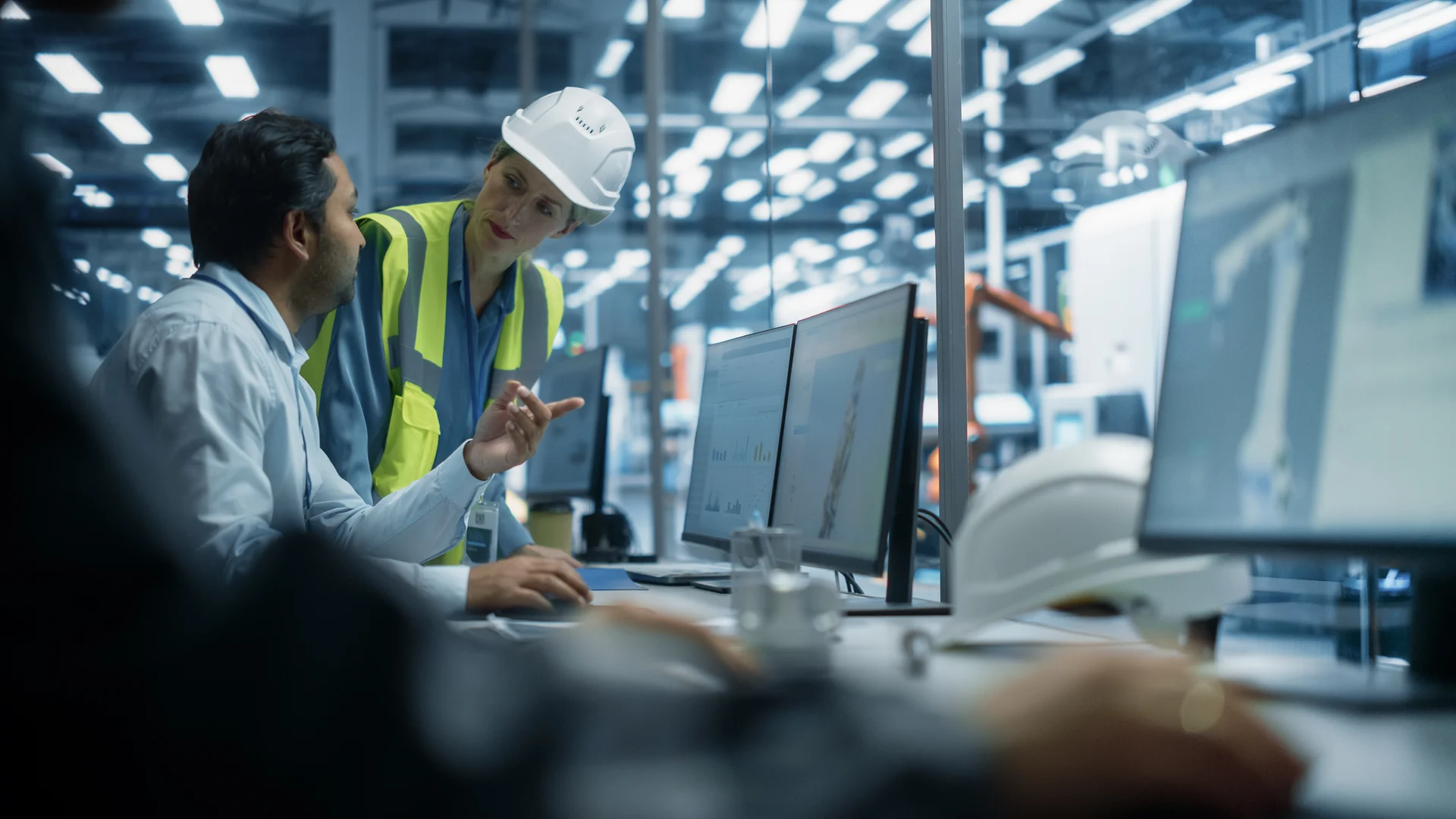 Manufacturing leaders reviewing production information on the factory floor