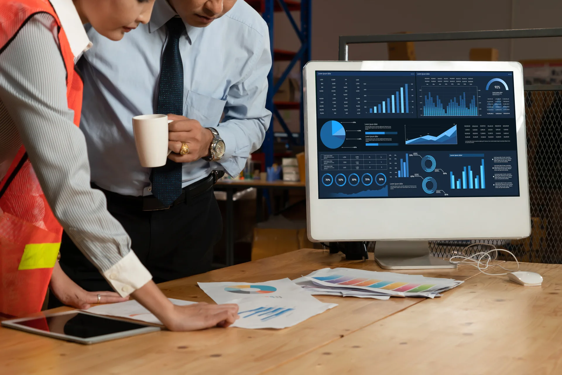 Operations leaders reviewing performance data on screens in a warehouse