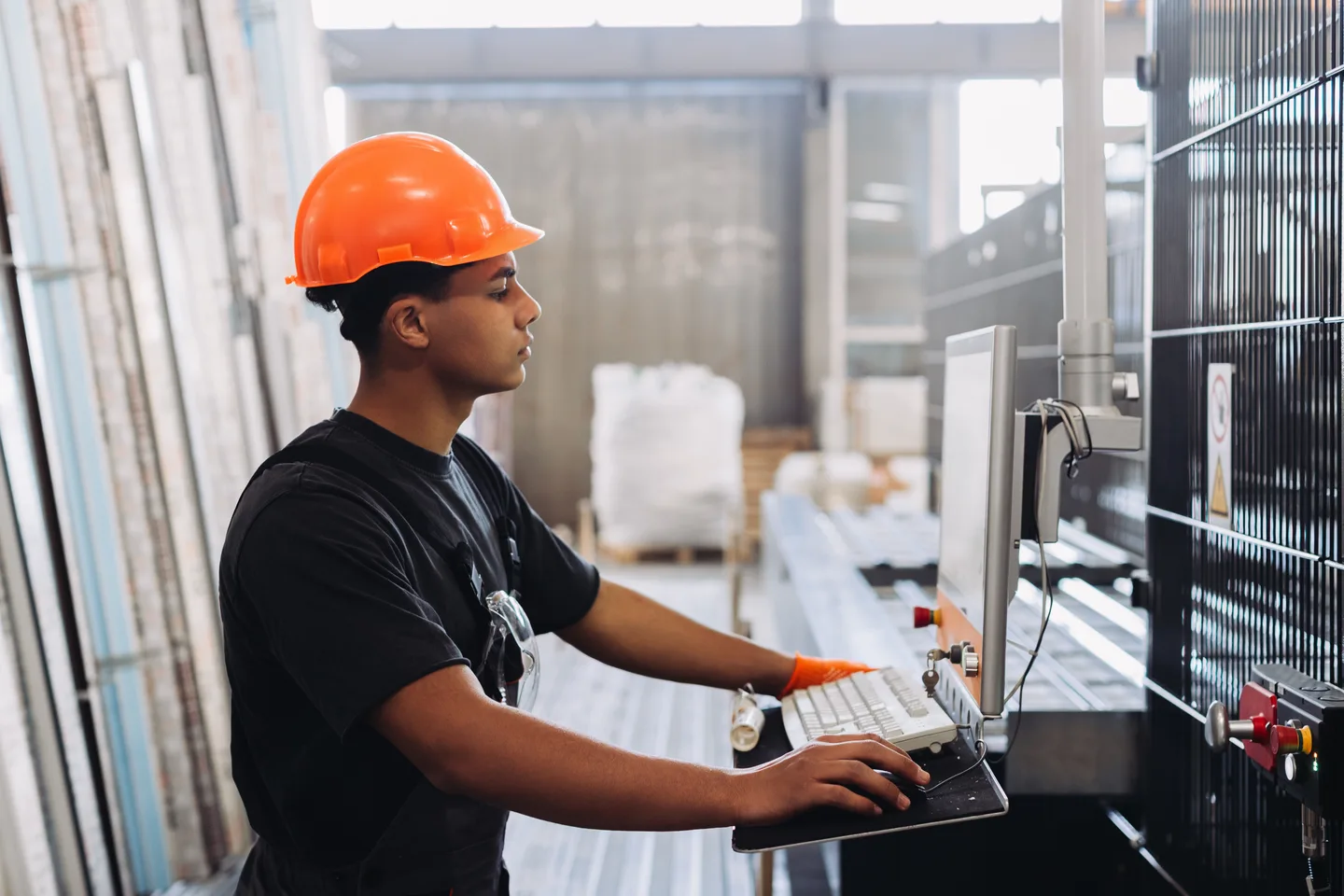 Operations worker monitoring systems at a warehouse workstation