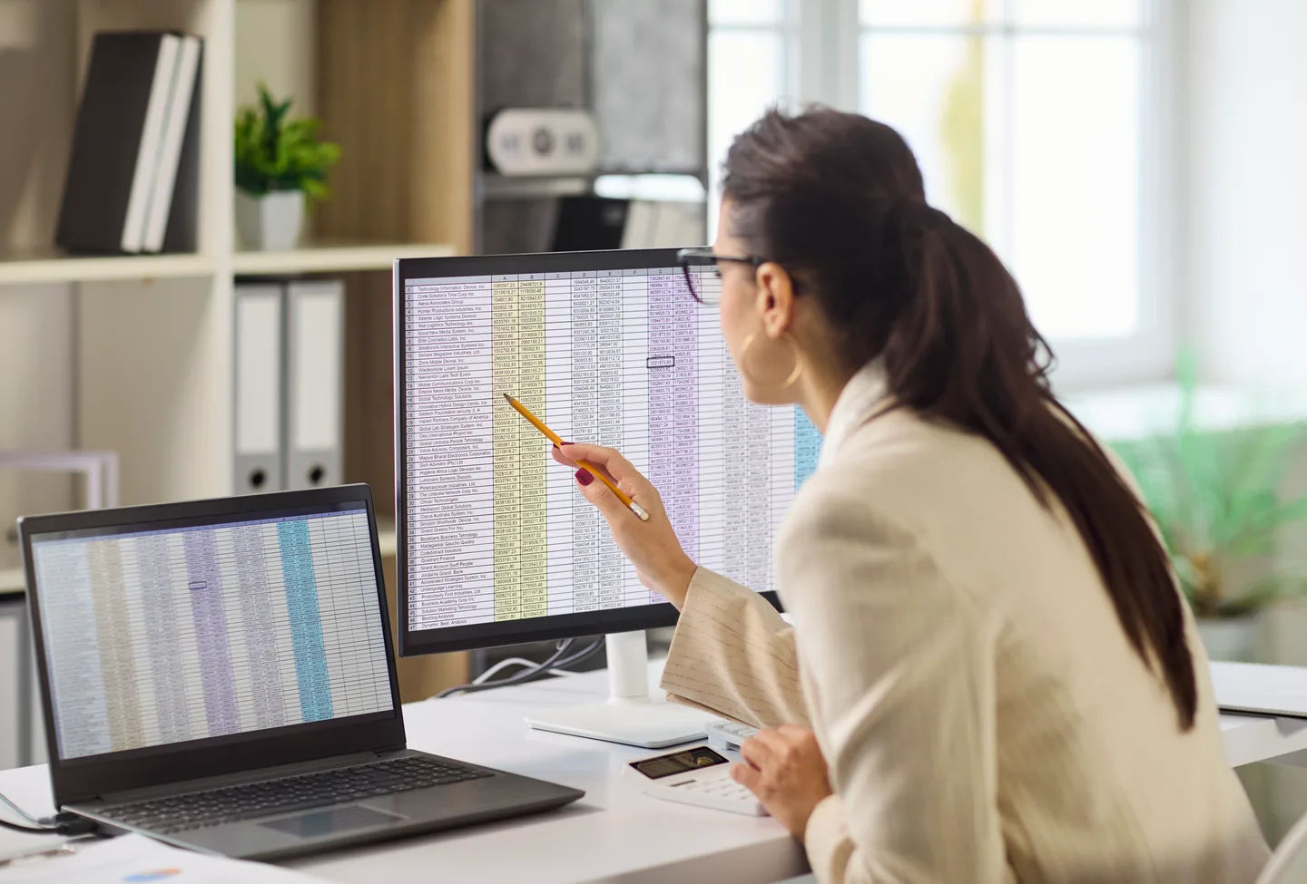 Analyst reviewing operational data on dual monitors