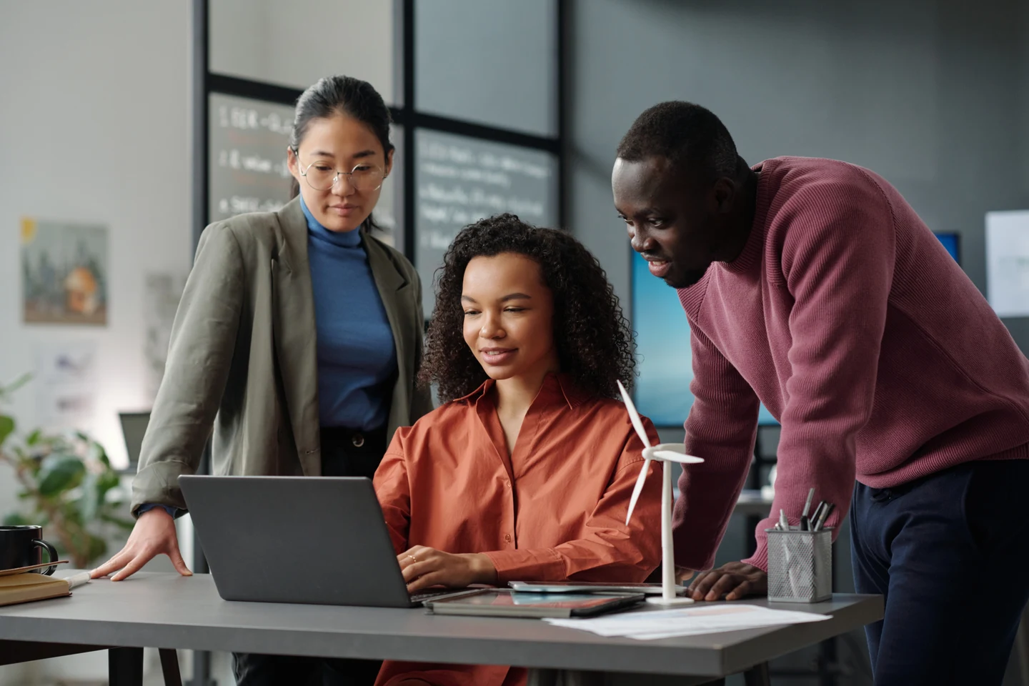 Colleagues reviewing a pricing scenario on a laptop